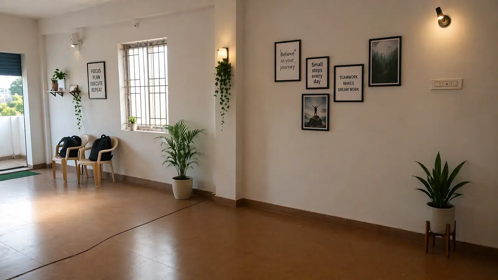 Open area inside the RED SAG office with framed posters, potted plants and chairs by the window