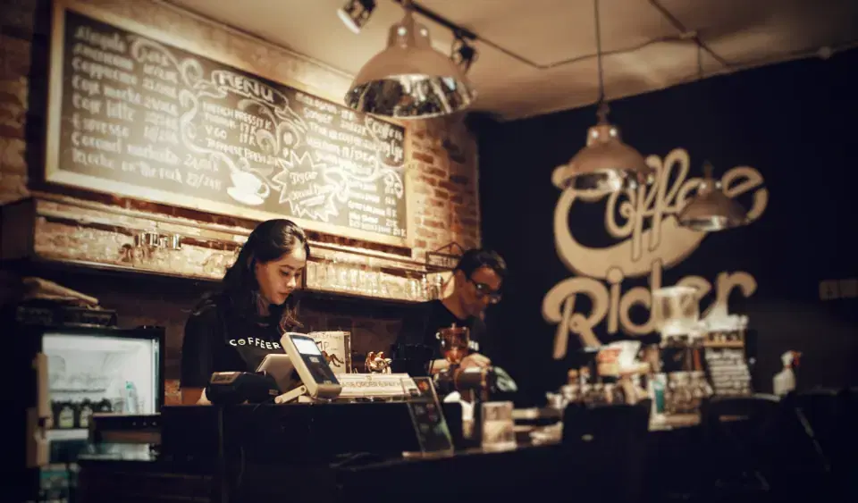 Staff at a cafe billing counter using a POS billing system
