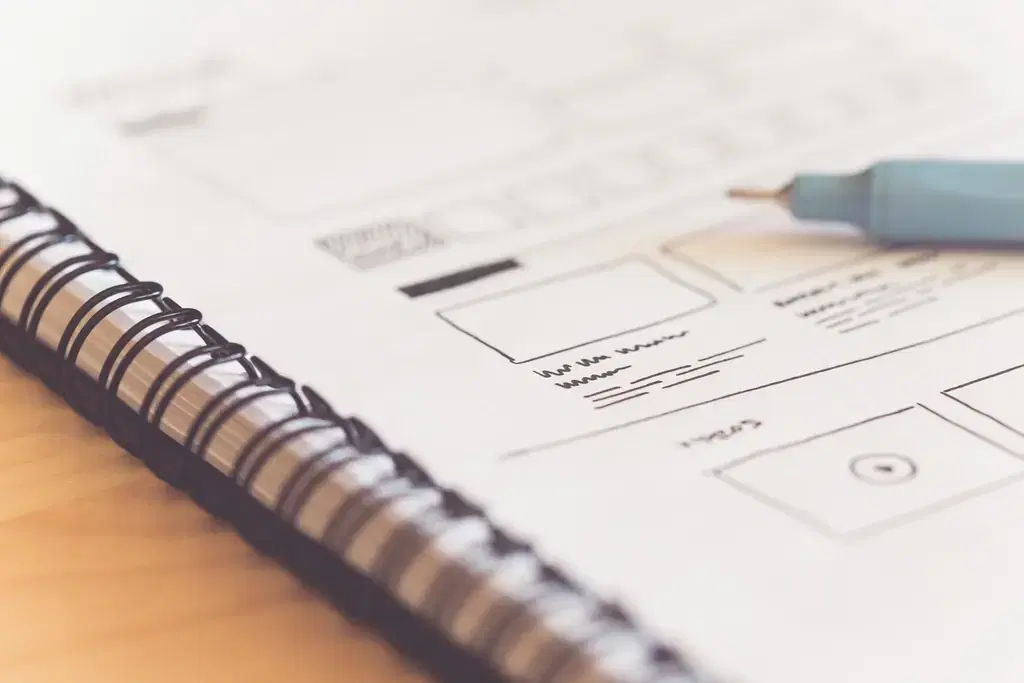Website wireframe sketch in a spiral notebook, early step in website development