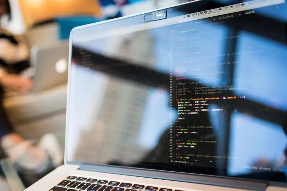Laptop showing web application code in an office, reflecting Next.js development work