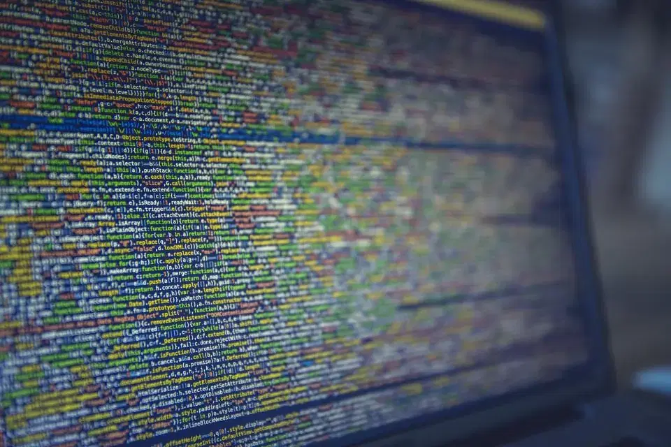 Monitor filled with dense source code, representing PHP and Laravel development