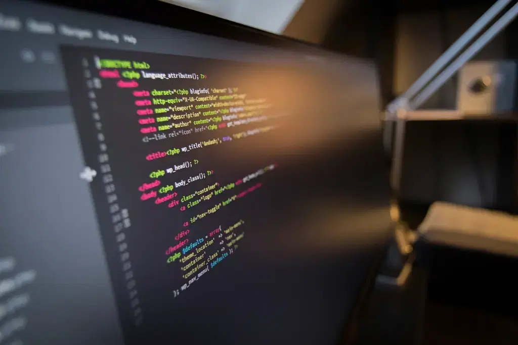 Colourful front-end component code on a monitor in a dim room, typical React work