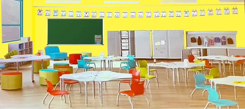 Bright, empty school classroom with colourful chairs, tables and a green chalkboard